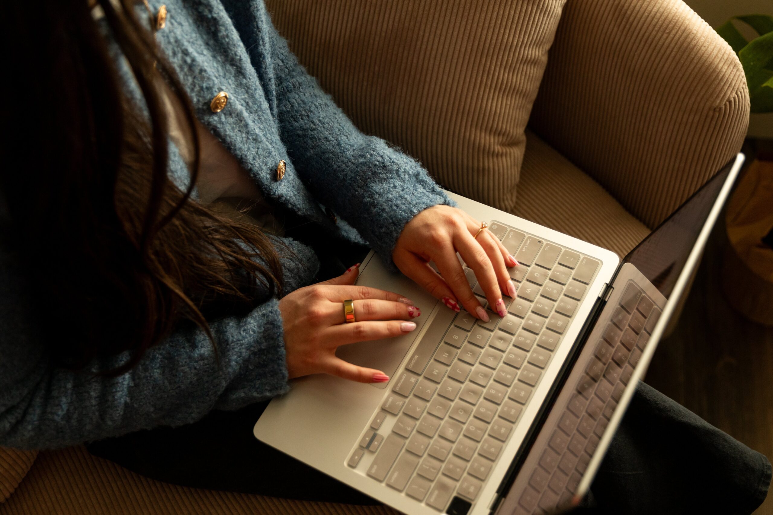 Image of hands on a computer working to show you how to choose a website builder