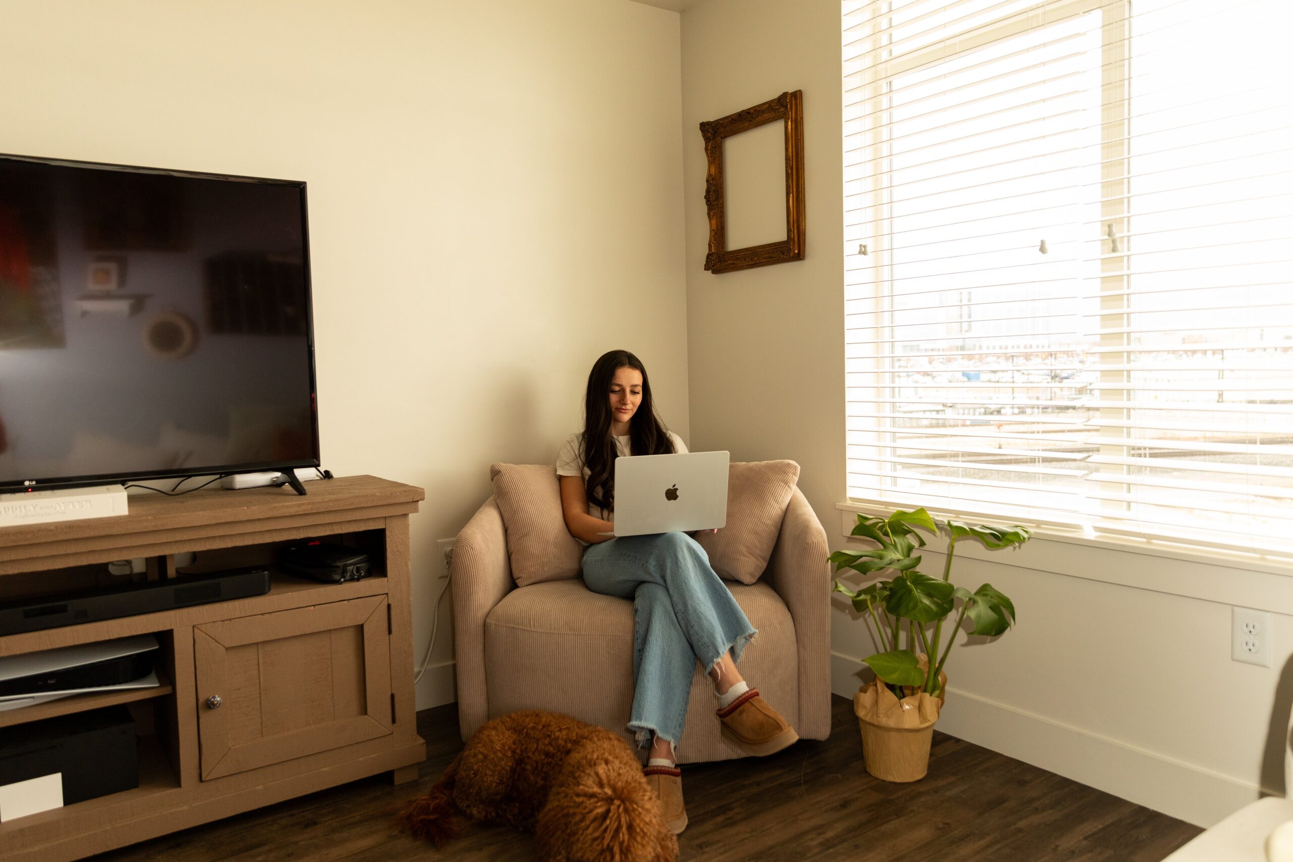 Abi of Flourish Foundry on a couch working on the best website building platform for small business