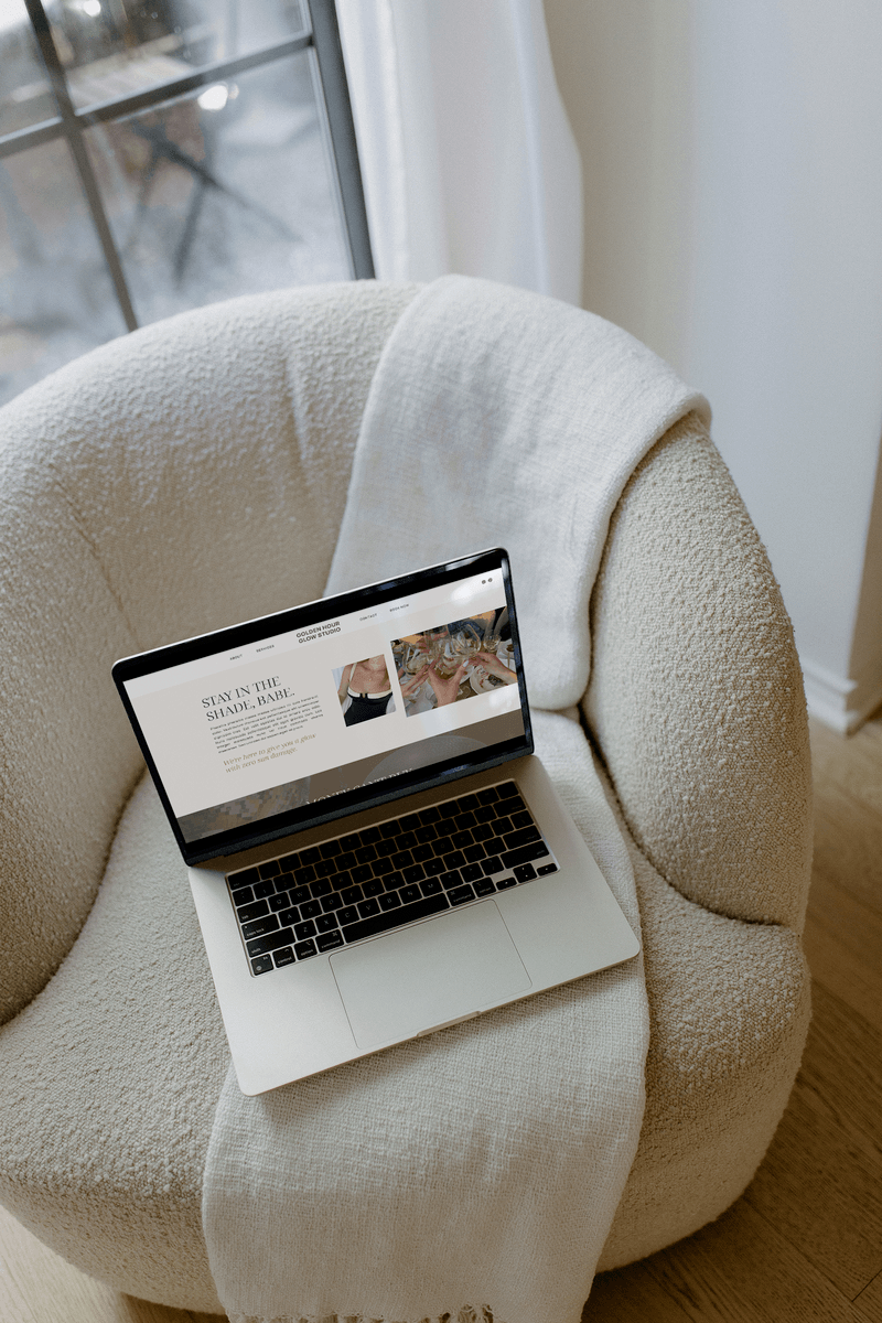 Laptop sitting on a chair for article comparing Showit vs WordPress