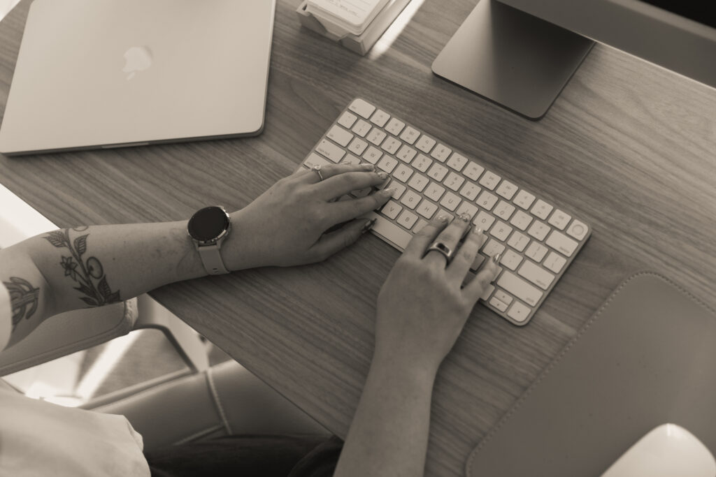 Hands on laptop to answer the question of is Wix a good ecommerce platform? 