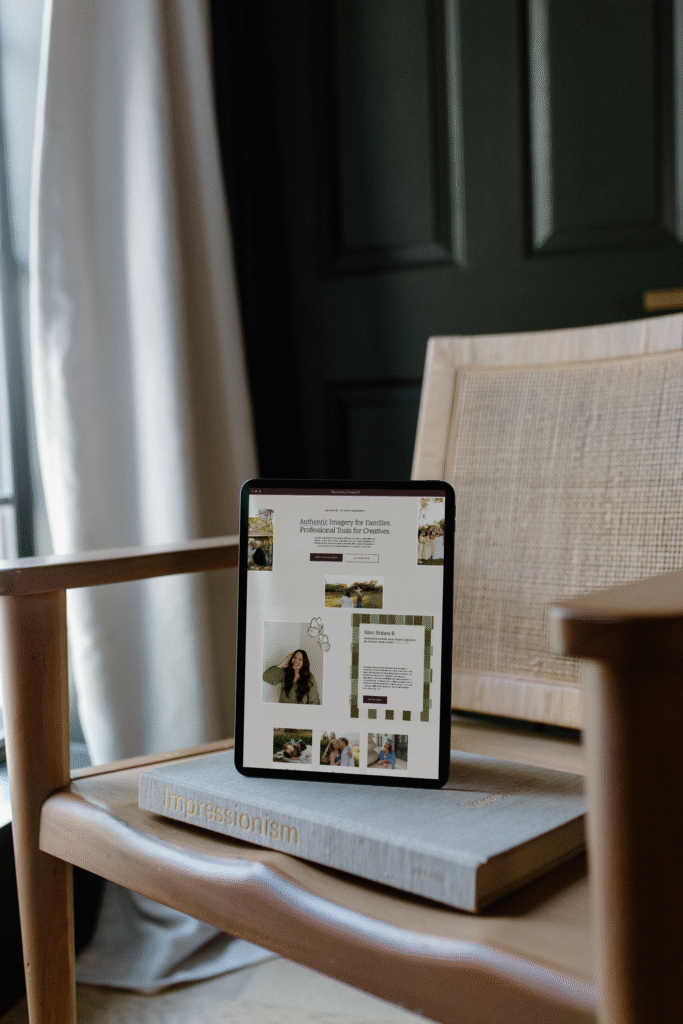 IPad on a chair, displaying a professional photography website with an elegant website layout. 